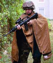 Soldier in hunt position with M16A2 5.56mm assault rifle and M68 Close Combat Optic