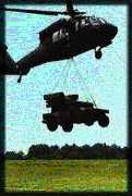 Avenger w/rocket-missile pods sling-loaded under Blackhawk helicopter
